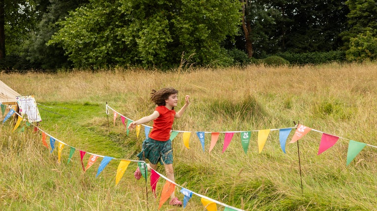 Children running in summer meadow National Trust Summer of play